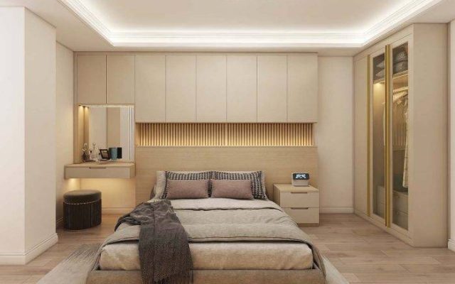 A modern bedroom with cabinets showcasing high - gloss finishes and LED - lit features.